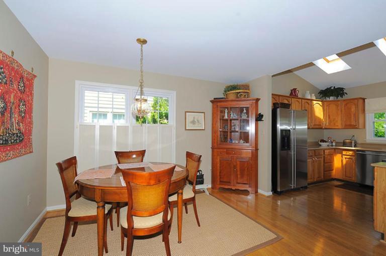 6583 Forsythia Street Springfield, VA 22150 - Photo 6 of 28 a dining room with furniture window and wooden floor