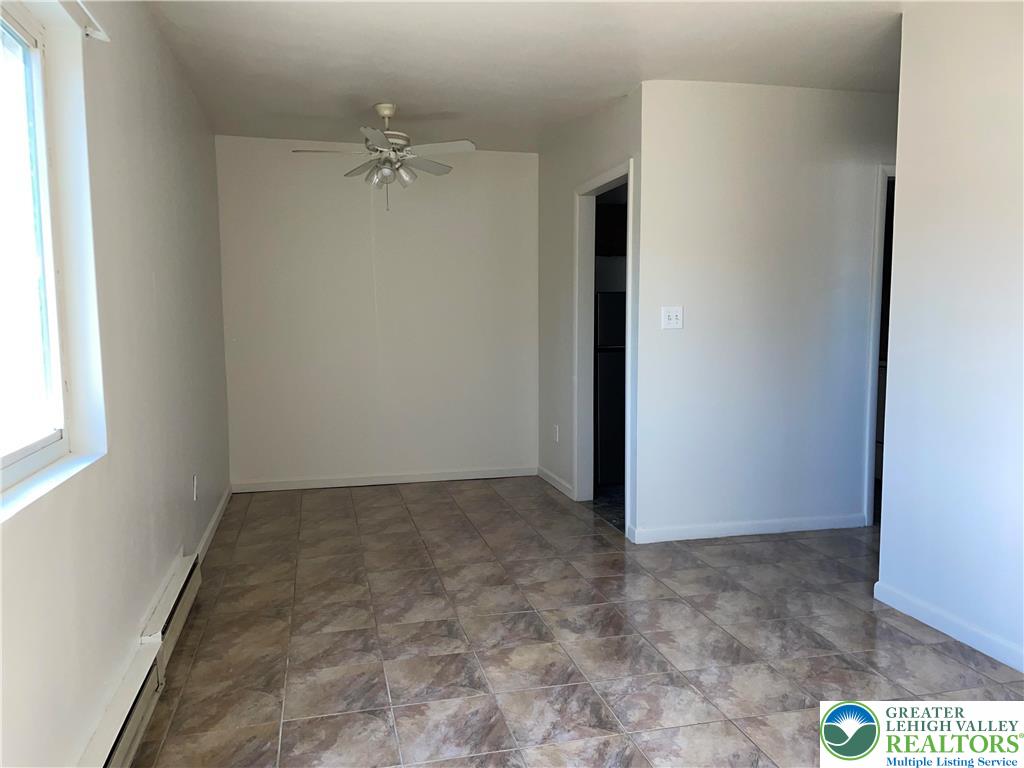 4429 Steuben Road, Unit 203 Bethlehem, PA 18020 - Photo 4 of 8 an empty room with a ceiling fan and a window
