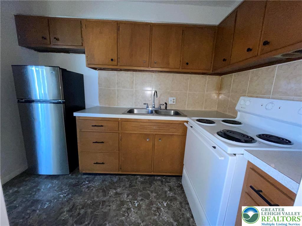 4429 Steuben Road, Unit 203 Bethlehem, PA 18020 - Photo 6 of 8 a kitchen with a sink a stove and refrigerator