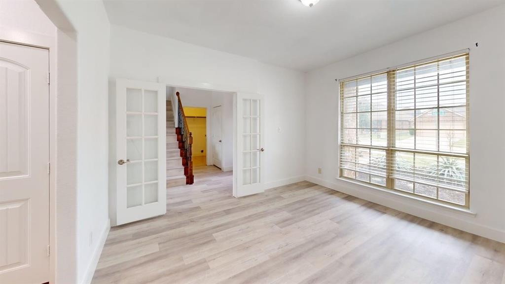 101 Rocky Pine Road McKinney, TX 75072 - Photo 15 of 39 wooden floor in an empty room with a window