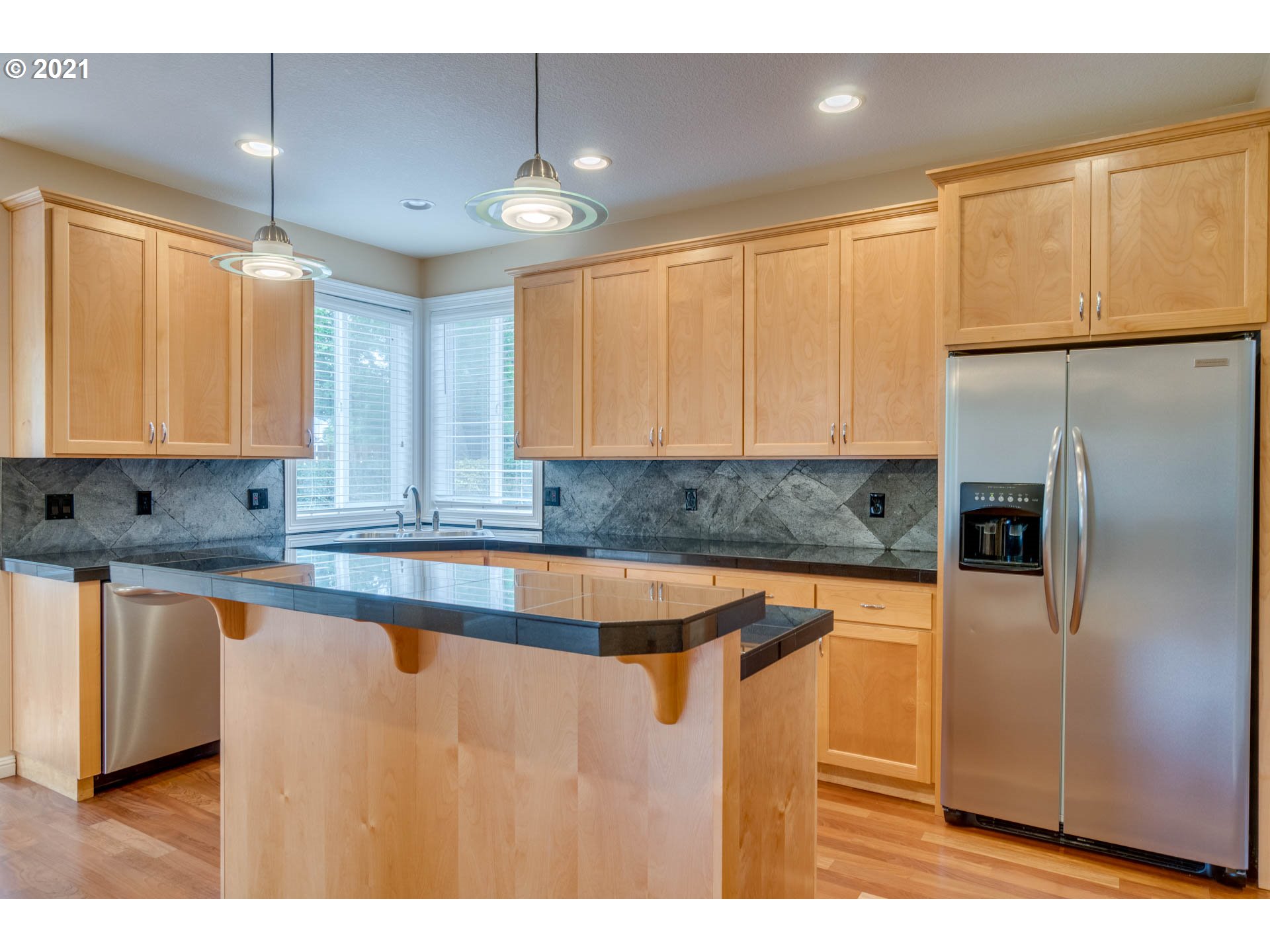 3113 Northwest 30th Circle Camas, WA 98607 - Photo 7 of 32 a kitchen with stainless steel appliances granite countertop a sink a stove and a refrigerator