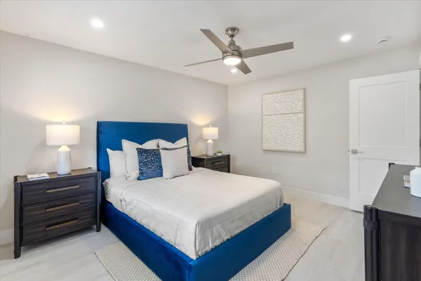 a bedroom with a bed and a chandelier