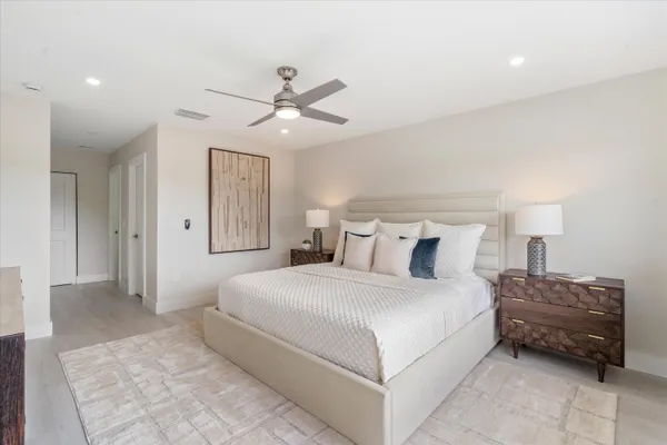 a bedroom with a bed and a chandelier