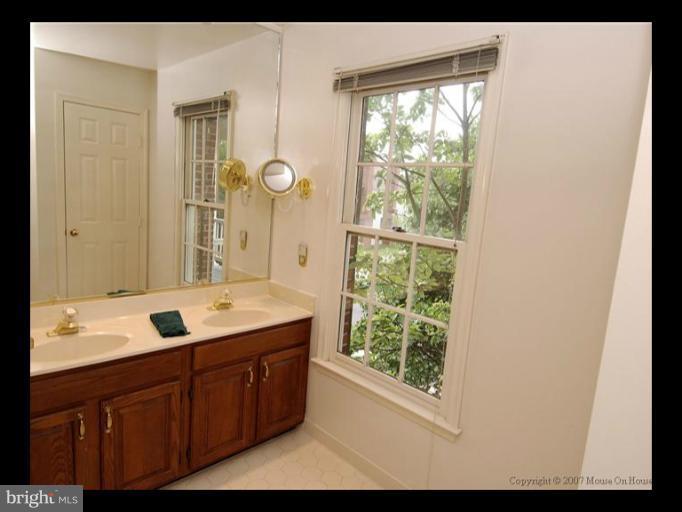 6601 Forsythia Street Springfield, VA 22150 - Photo 11 of 26 a bathroom with a granite countertop sink mirror and window
