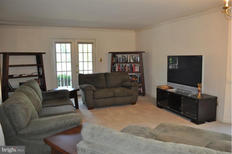 6601 Forsythia Street Springfield, VA 22150 - Photo 3 of 26 a living room with furniture and a flat screen tv