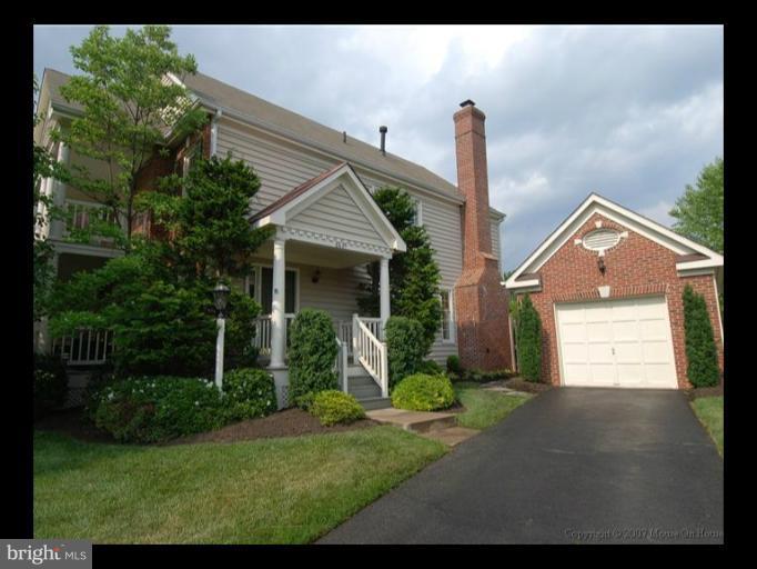 6601 Forsythia Street Springfield, VA 22150 - Photo 20 of 26 a front view of a house with garden