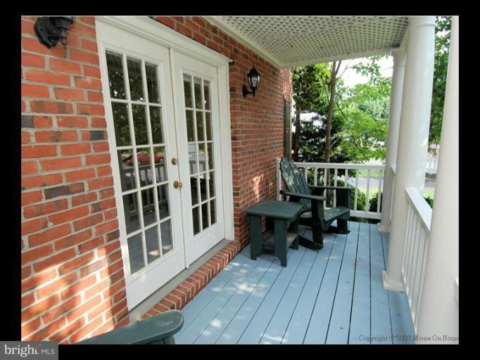 6601 Forsythia Street Springfield, VA 22150 - Photo 21 of 26 a view of balcony with wooden floor and outdoor seating