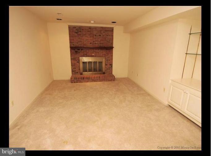 6601 Forsythia Street Springfield, VA 22150 - Photo 22 of 26 a view of empty room with a fireplace