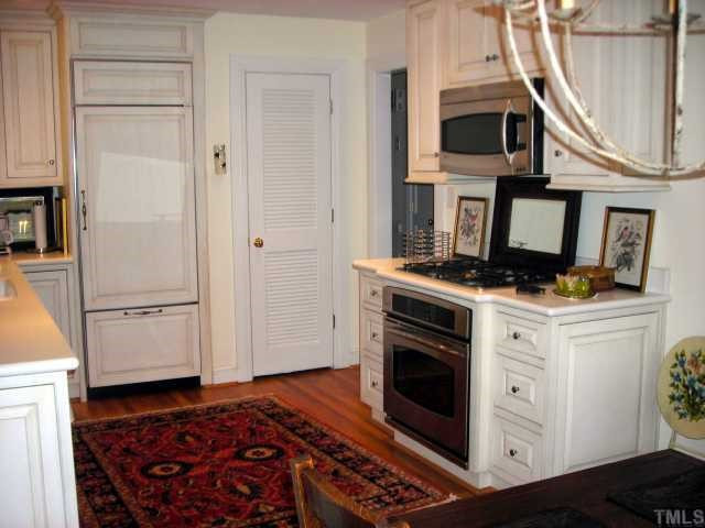 707 Richmond Street Raleigh, NC 27609 - Photo 4 of 12 Beautifully renovated includes all new appliances, Subzero refrigerator with panels matching cabinets, solid surface countertops, hardwood floors, open and light. Kitchen