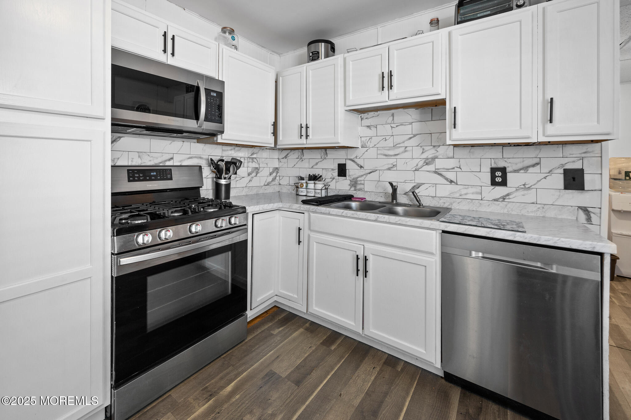14 Georgetown Boulevard Barnegat, NJ 08005 - Photo 12 of 39 a kitchen with granite countertop a sink dishwasher a stove and a microwave oven with cabinets