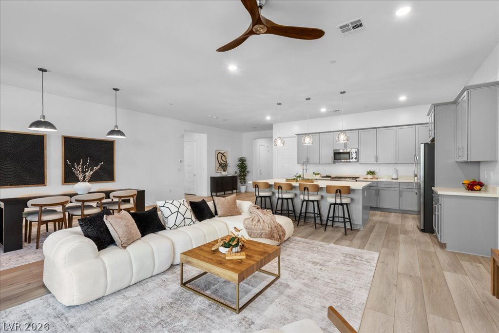 20 Charlotte Ridge Place Henderson, NV 89011 - Photo 9 of 33 An open concept living area boasts a sleek kitchen with a spacious island, perfect for entertaining.
