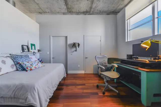 a bedroom with bed and a chair