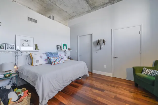 a bedroom with a bed and a chair in it