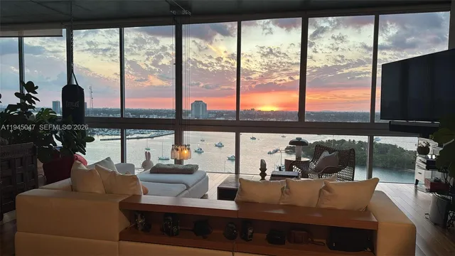 a living room with furniture and a floor to ceiling window