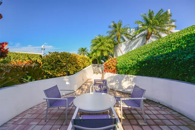 a balcony with table and chairs