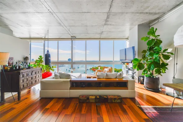 a living room filled with furniture and a potted plant