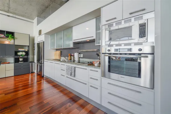 a kitchen with stainless steel appliances granite countertop a stove and a refrigerator