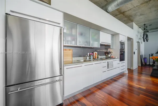 a kitchen with stainless steel appliances a refrigerator and wooden cabinets