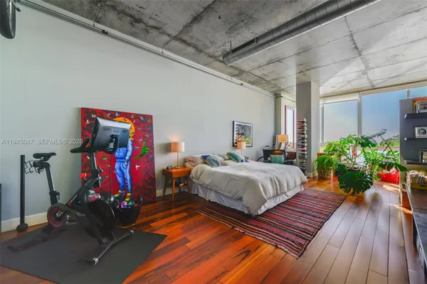 a bedroom with bed and a potted plant