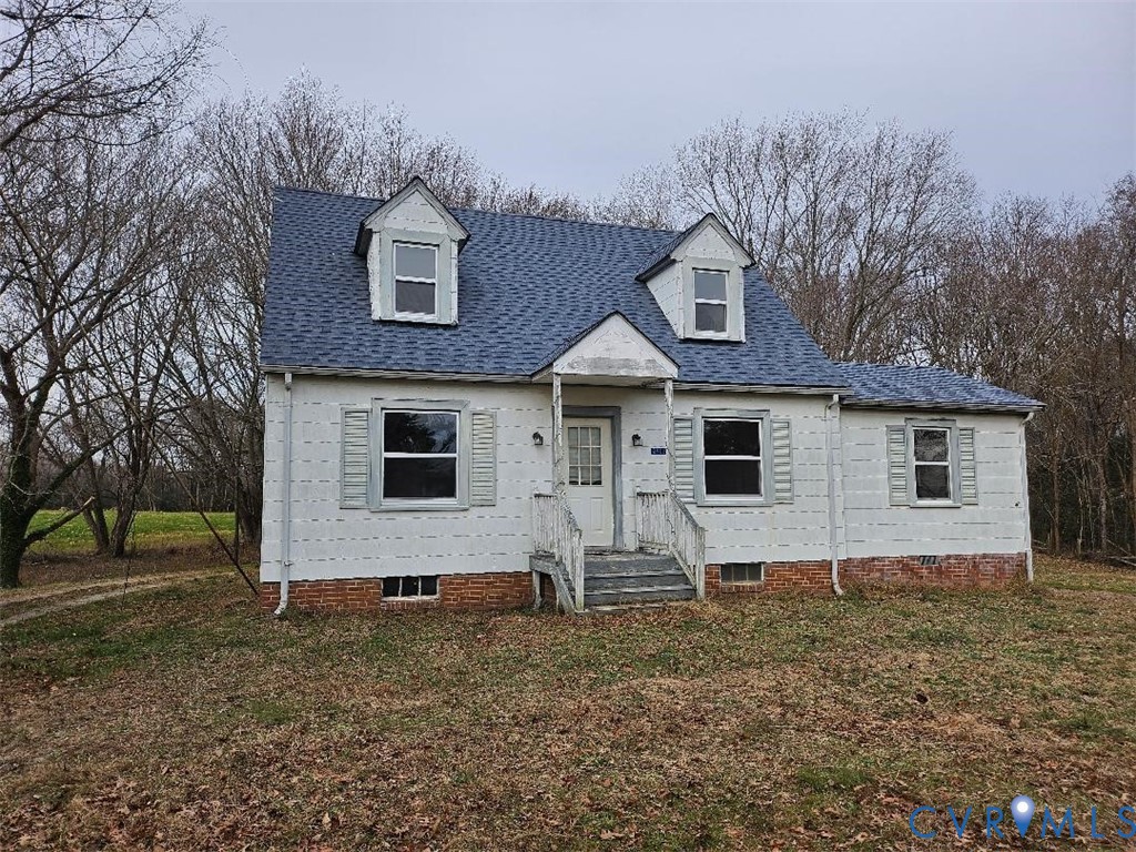 View of front of house featuring a shingled roof a