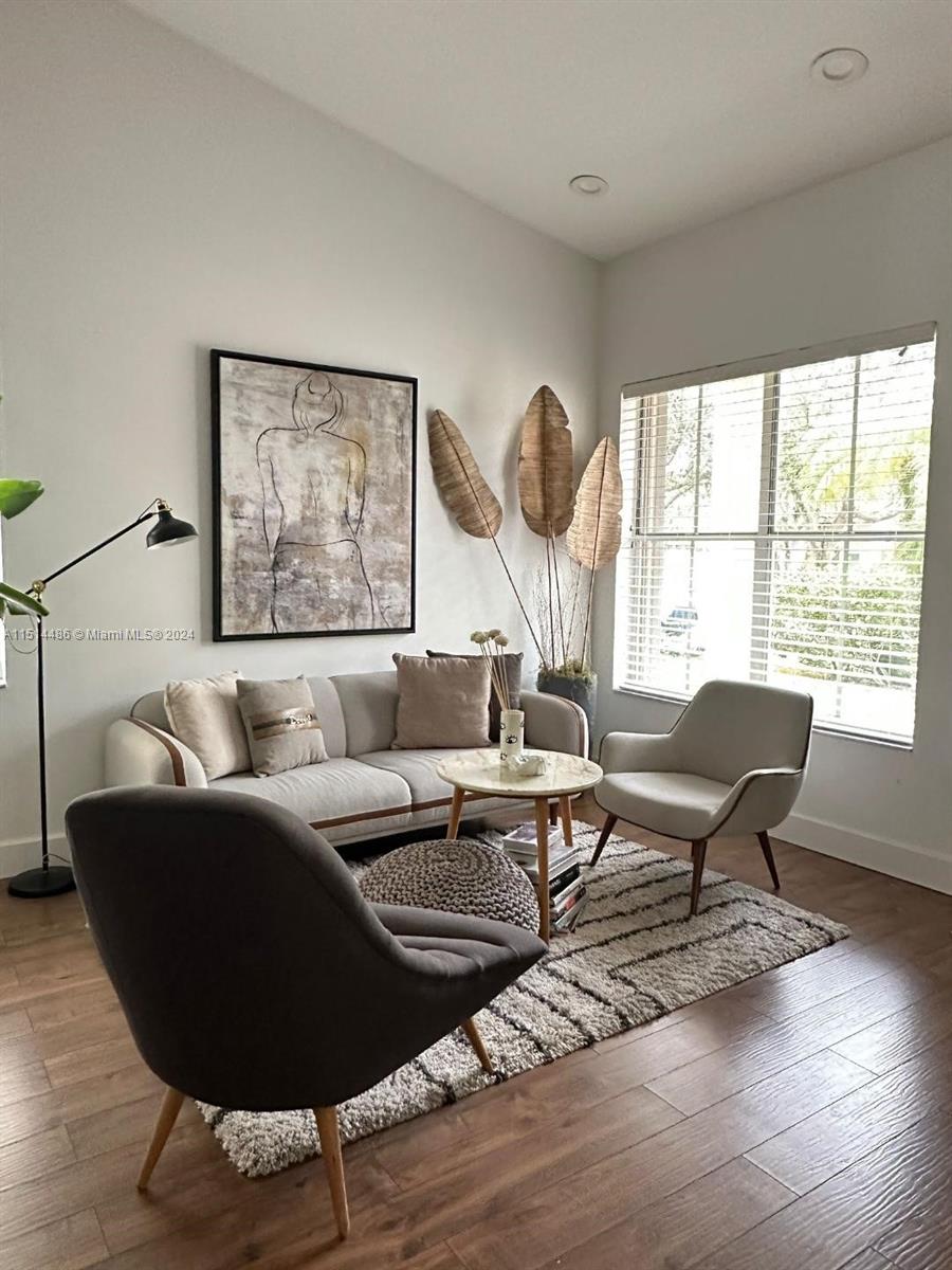 a living room with furniture and a large window
