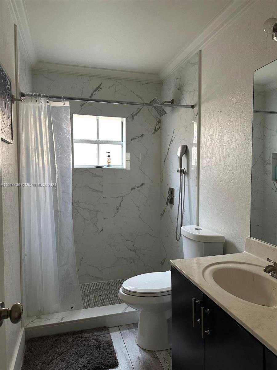 941 Falling Water Road, Unit 941 Weston, FL 33326 - Photo 4 of 4 a bathroom with a sink a toilet and shower