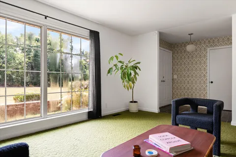 a view of a livingroom with furniture and window