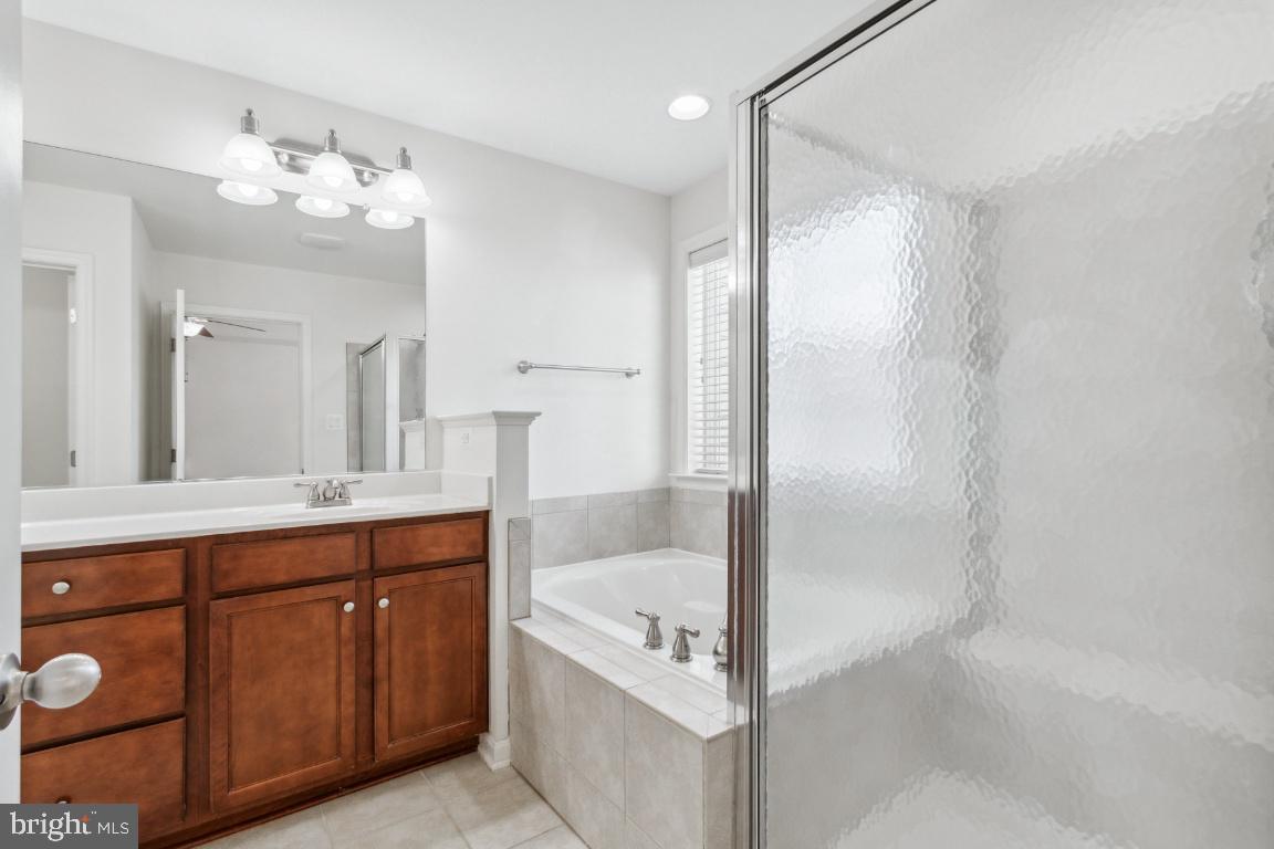 42219 Dean Chapel Square Chantilly, VA 20152 - Photo 12 of 21 a bathroom with a tub sink and mirror