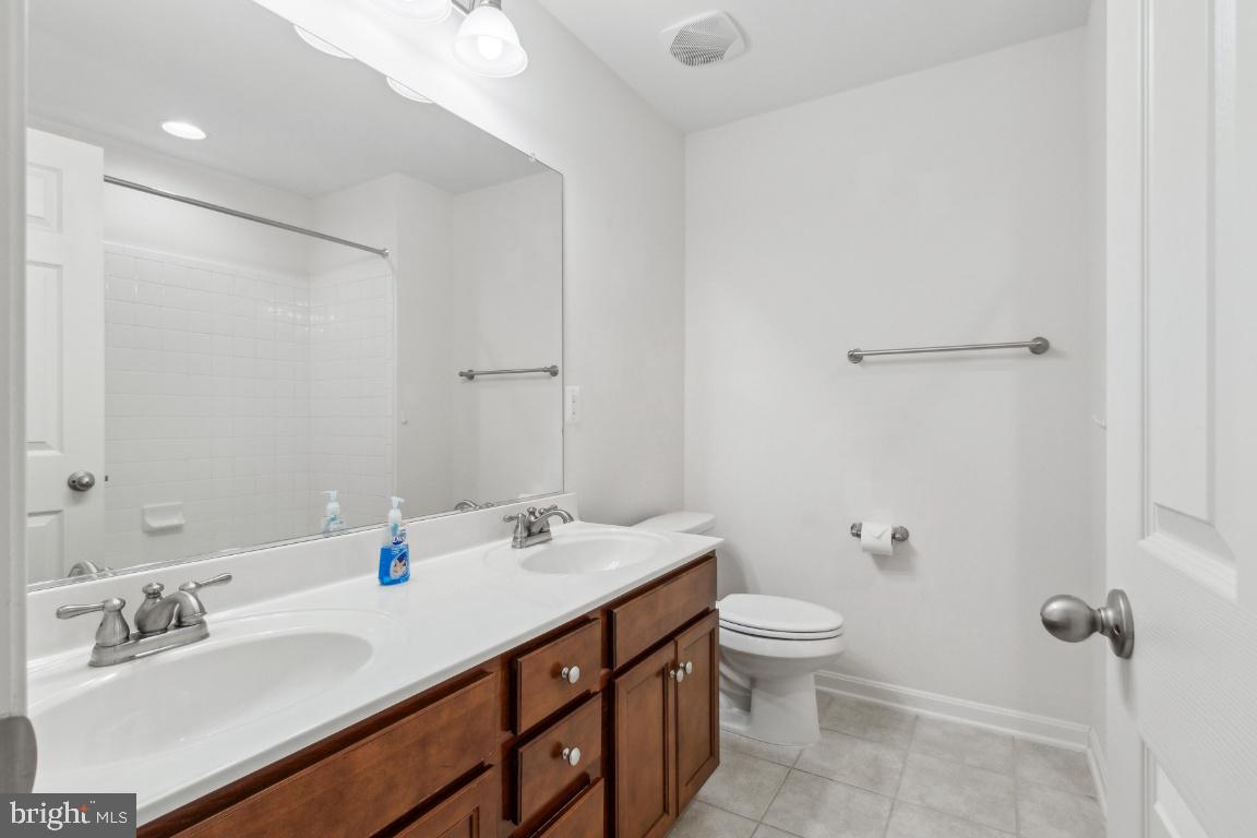 42219 Dean Chapel Square Chantilly, VA 20152 - Photo 15 of 21 a bathroom with a double vanity sink toilet and mirror