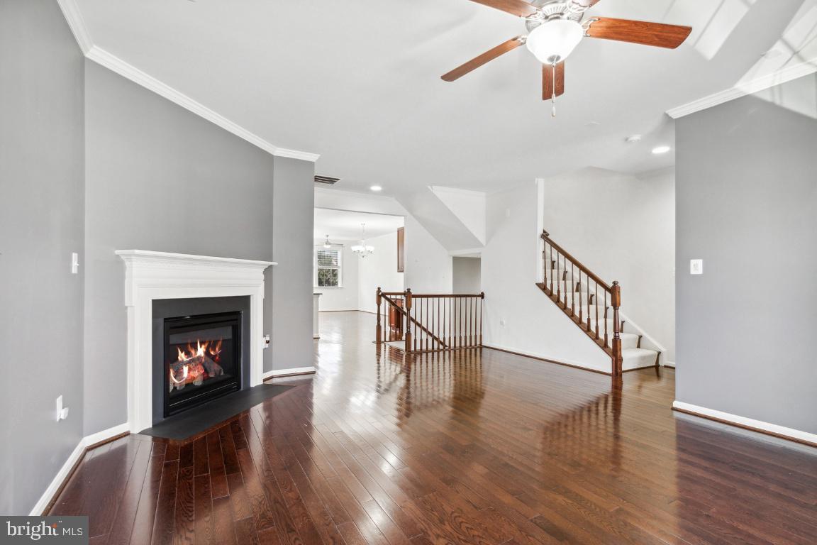 42219 Dean Chapel Square Chantilly, VA 20152 - Photo 4 of 21 a living room with wooden floor and a fireplace