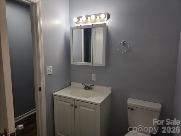 a bathroom with a toilet sink and mirror
