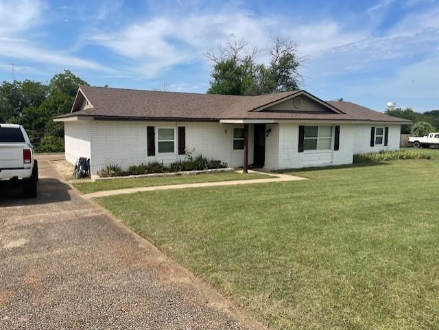 130 Castleman Circle Hewitt, TX 76643 - Photo 7 of 13 a front view of a house with a garden and yard