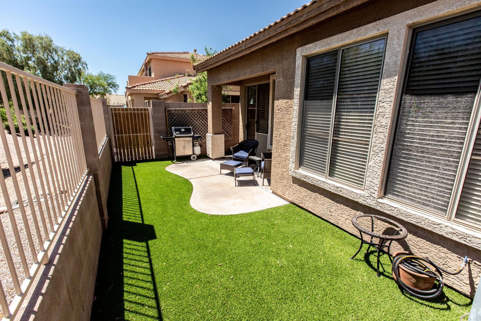 5415 East McKellips Road Mesa, AZ 85215 - Photo 9 of 14 a view of a backyard with table and chairs and wooden fence