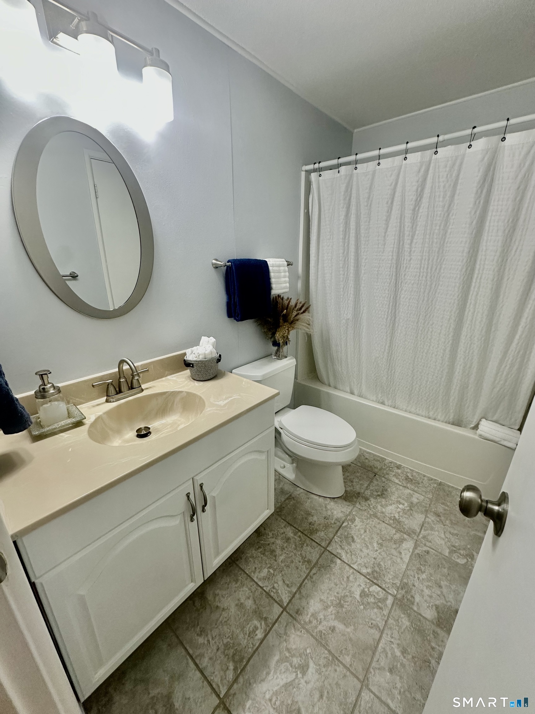 2 Lakeside Drive, Unit M Ledyard, CT 06339 - Photo 25 of 38 a bathroom with a double vanity sink toilet and a mirror