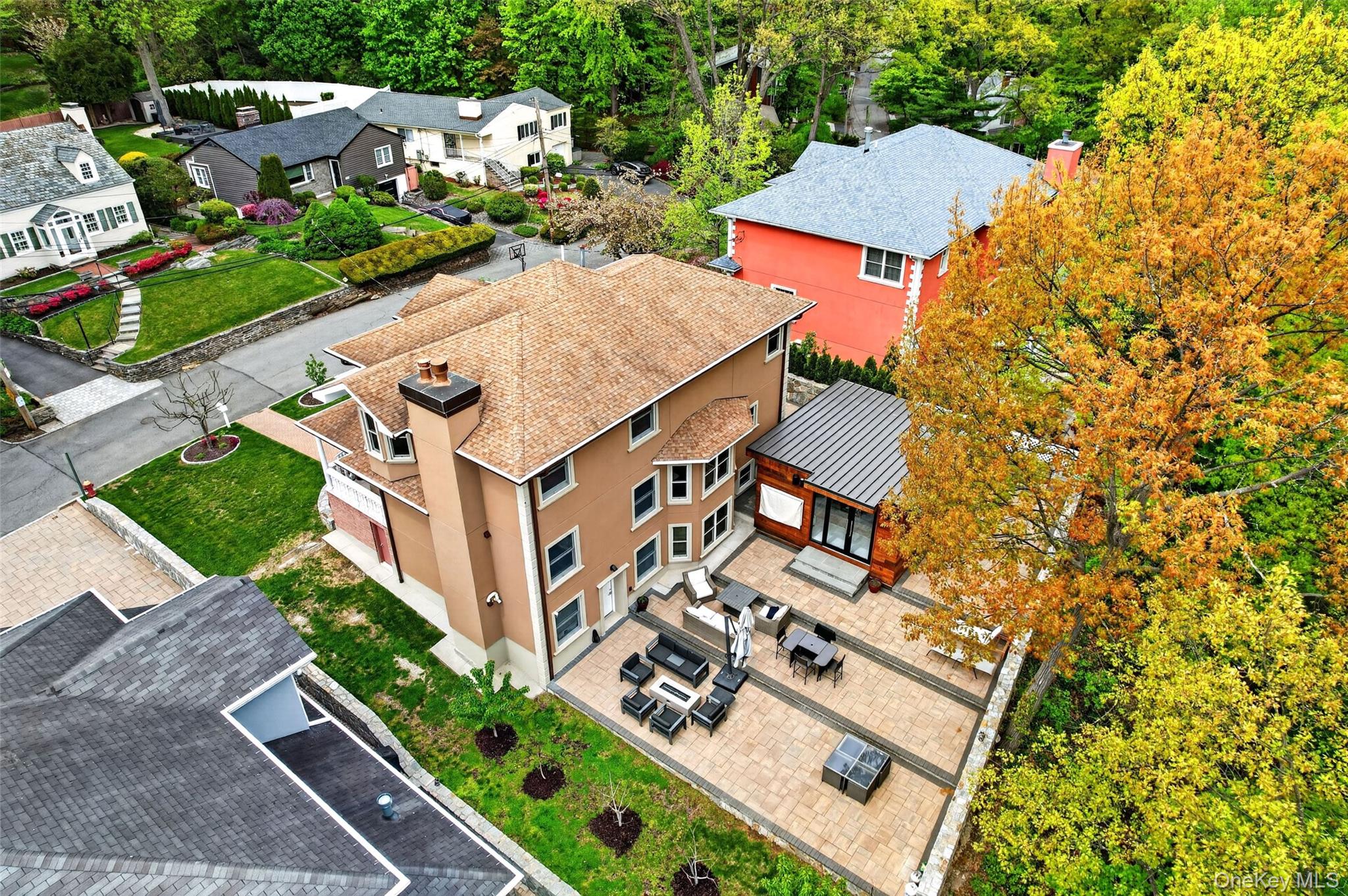 65 Wildway Bronxville, NY 10708 - Photo 15 of 42 Spacious paved patio area featuring a modern detached structure with large windows and a metal roof