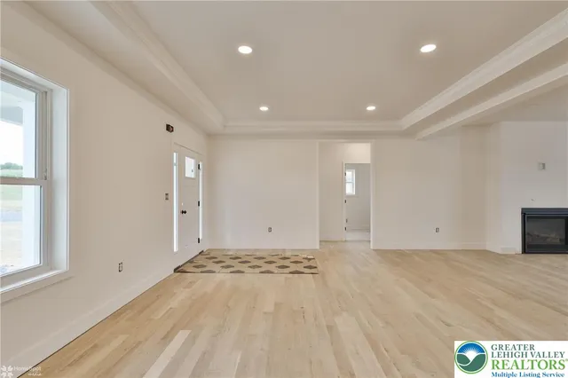a kitchen that has a lot of white cabinets and wooden floor