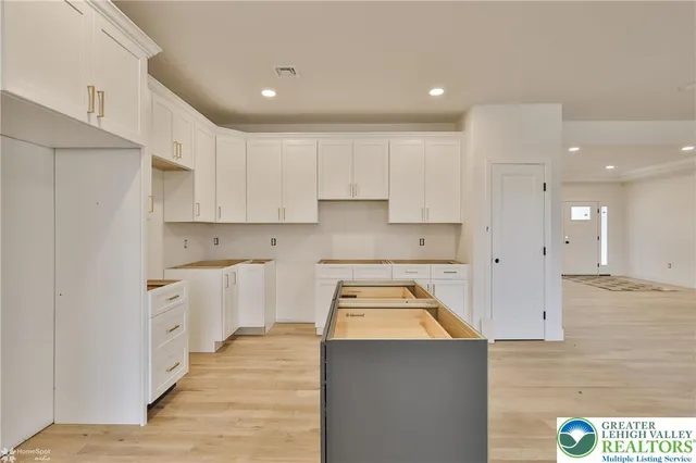 a front view of house with yard and trees around