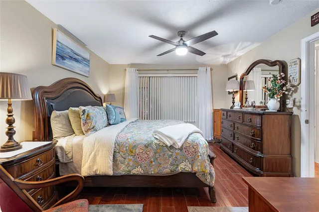 a bedroom with a bed and ceiling fan