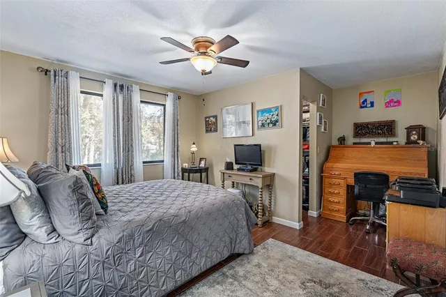 a bedroom with a bed and a view of kitchen