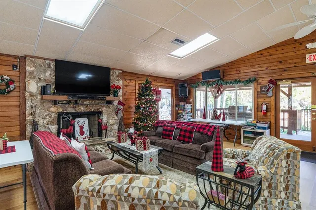 a living room with fireplace furniture and a flat screen tv