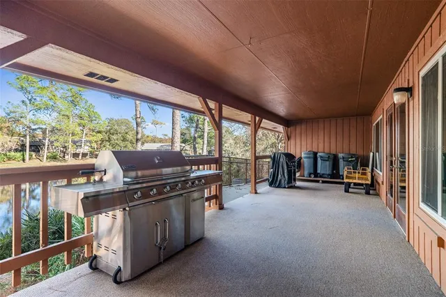 a view of a porch with chairs in front of a yard