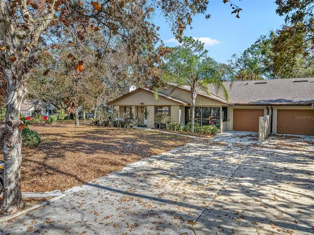a view of a house with a yard and tree