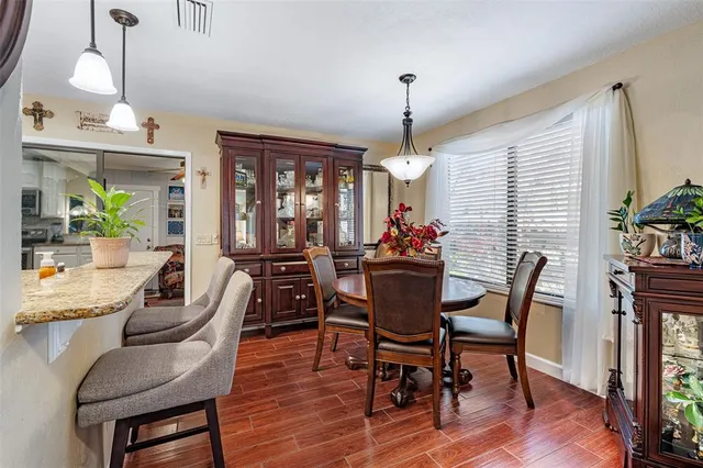 a view of a dining room with furniture window and wooden floor