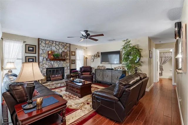 a living room with furniture a flat screen tv and a fireplace