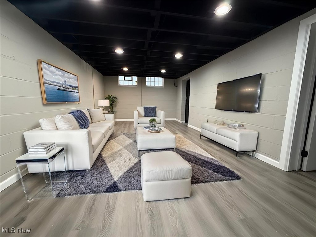 6807 Gerald Avenue Parma, OH 44129 - Photo 22 of 25 Living room with recessed lighting, wood finished floors, and concrete block wall virtually staged