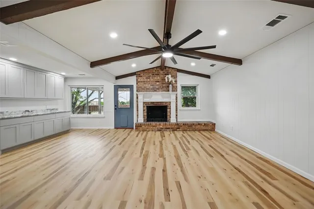 a view of an empty room and fire place