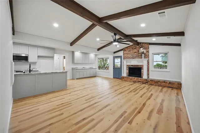 a large kitchen with kitchen island a sink stainless steel appliances and cabinets