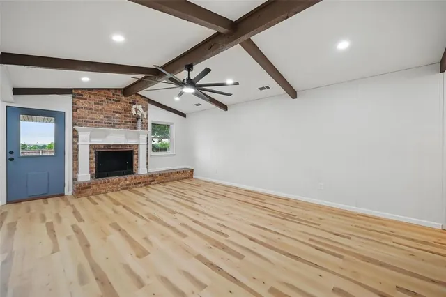 wooden floor in an empty room with a fireplace