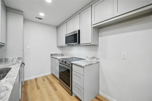 a kitchen with a stove and a microwave