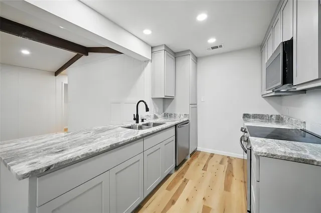 a kitchen with a sink stove and cabinets